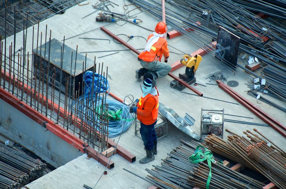 Workers in hi-vis and hard hats on a construction site